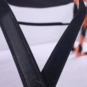 Detail of the black hook and loop fastener straps for the Halloween pet spider costume