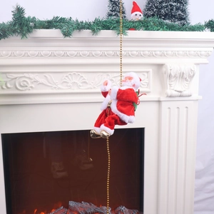 Electric climbing Santa Claus toy on golden bead chain against white fireplace decor