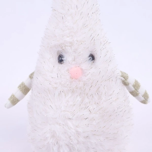Close-up of white plush Christmas ornament with silver tinsel and gold striped fabric detail