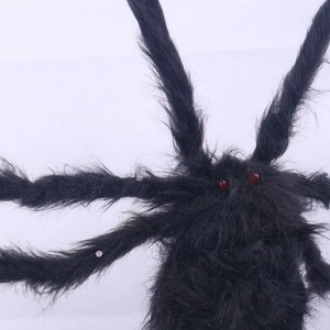 Close-up of a large black furry Halloween spider with glowing red eyes for spooky decor