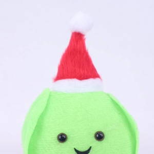 Close-up of green plush Christmas doll with red hat showing soft fabric and sewing detail