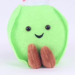 Detailed close-up of cute green sprout plush doll with soft fabric and embroidered smile