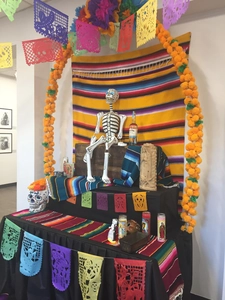 Detailed Day of the Dead altar set with marigolds, papel picado, and skull decor