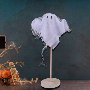 Ghost Halloween decoration with white mesh fabric on a round wooden stand and base