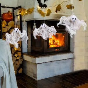 Detailed view of three hanging white ghost decorations with mesh fabric for Halloween decor