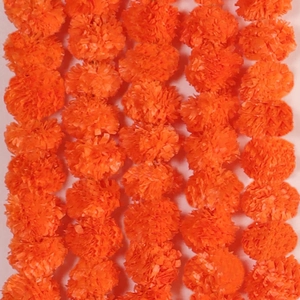 Close-up of vibrant orange marigold garlands for Diwali and wedding festival decor