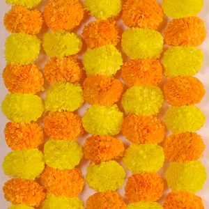 Close-up of yellow and orange artificial marigold flower garlands for festival decor