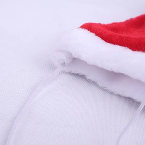 Detail of red plush Christmas pet hat showing white fluffy trim and elastic strap