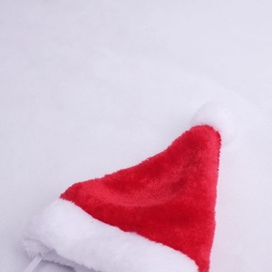 Detail of red plush Christmas pet hat with white faux fur trim and adjustable elastic strap