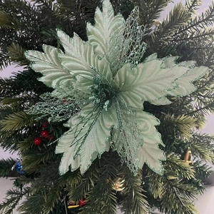 Close-up of mint green Christmas poinsettia flower with glitter mesh petals on tree