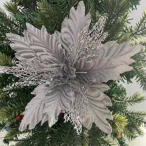 Close-up of silver mesh poinsettia flower decoration with glitter on Christmas tree
