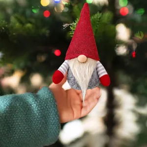 Christmas gnome hanging ornament with red hat and white beard on festive tree background