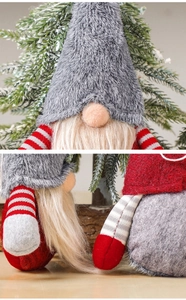 Detail of plush Christmas gnome with gray felt hat and striped knit body texture
