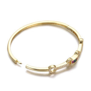 Detail of golden snake head bangle with colorful crystals and micro-pave setting on hinge