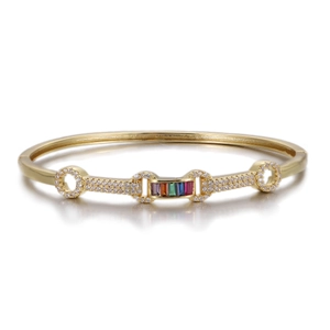 Detail of gold open bangle with colorful baguette stones and pavé cubic zirconia