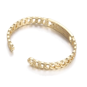 Detail of golden heart bangle with chain link design and micro-pave zircon setting