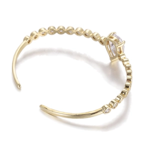 Elegant gold-plated open bangle with heart-shaped crystal and surrounding zircon stones