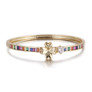 Detail of gold open bangle with clover motif, clear zircon and rainbow baguette stones