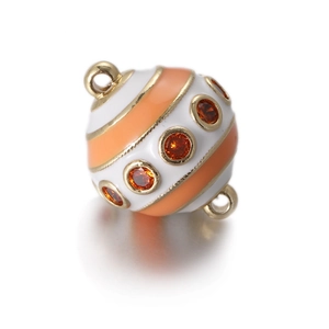 Detail of colorful enamel egg pendant with red zircon inlay and gold metal plating