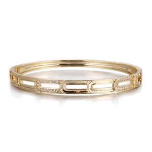 Detail of a gold-plated paperclip bangle with micro-pave white zircon inlay on white background