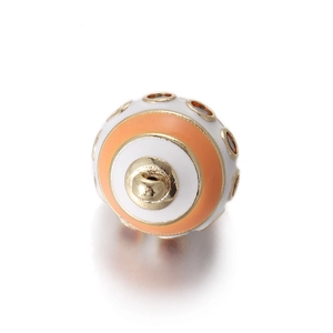 Macro shot of egg-shaped enamel charm with orange stripes and gold-tone metal hook