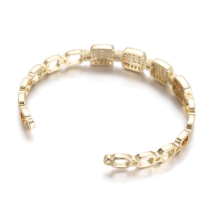 Detailed view of vintage gold open bangle with geometric chain links and cubic zirconia