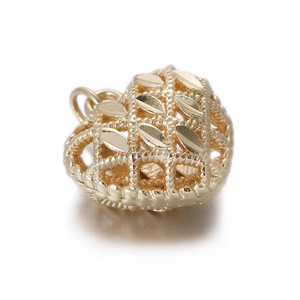 Detailed view of a hollow heart-shaped gold pendant with intricate mesh and leaf patterns