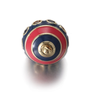Detail showing the red and blue enamel egg pendant with a gold loop and metallic textures
