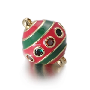 Macro view of egg-shaped alloy pendant with red and green enamel and crystal inlays