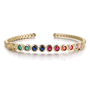 Detail of gold open cuff bracelet featuring multi-colored gradient gemstone inlay