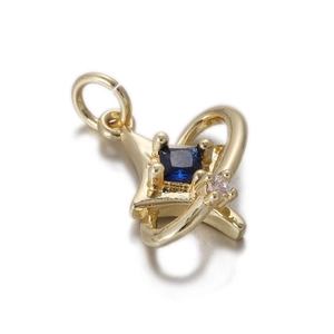 Detail of golden star pendant with blue gemstone and orbital ring design