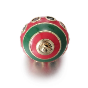 Macro view of egg-shaped enamel pendant charm with red and green stripes and gold accents