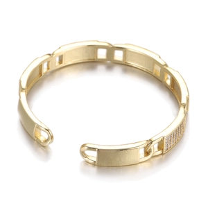 Detail of gold open cuff bracelet with micro-pave clear cubic zirconia link pattern