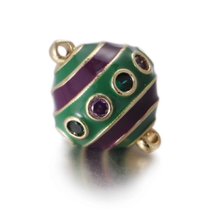 Detail of colorful egg-shaped charm with green purple enamel and inlaid crystals
