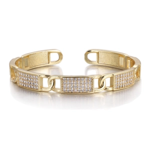 Detailed view of gold-plated open bangle with geometric zircon paving and oval links