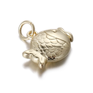Macro view of gold fish-shaped pendant featuring detailed scales and a polished finish