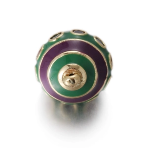 Macro view of a colorful enamel egg pendant with gold base for DIY jewelry making