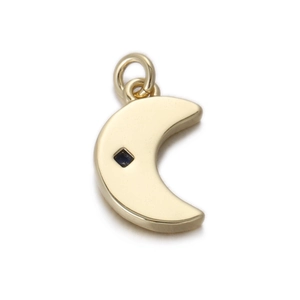 Detail of a crescent moon pendant in gold with a central blue square-cut gemstone