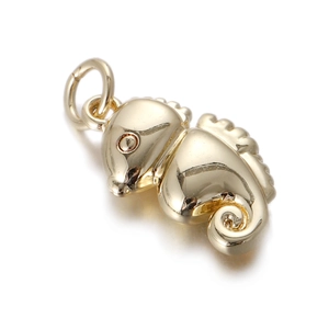 Detailed close-up of a golden seahorse pendant with cubic zirconia inlay and polished finish