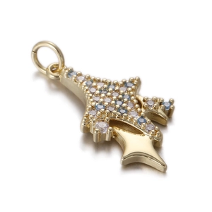 Detailed close-up of a gold Christmas tree pendant with blue and white zircon stones