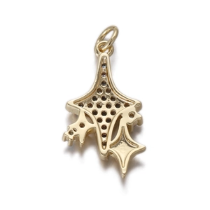 Close-up of golden hollow star pendant with geometric lines and hanging ring