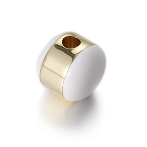 Close-up of golden cylindrical bead with white enamel inlay for DIY jewelry making