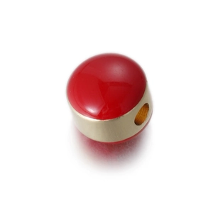 Detailed view of red enamel and gold metal egg pendant bead for DIY jewelry making