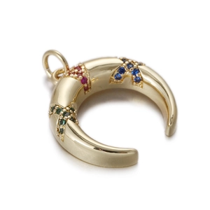 Detail of vintage gold crescent pendant with colorful inset gemstones and top ring loop