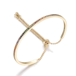 Detail of adjustable gold-plated bracelet with rainbow zircons and slider chain closure