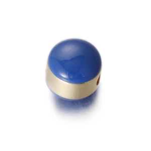 Macro view of egg-shaped royal blue enamel charm bead with gold-plated metal band