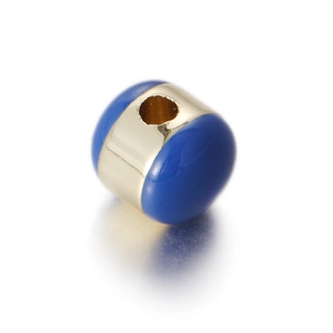 Detailed macro shot of blue enamel egg-shaped metal bead with a gold-plated finish