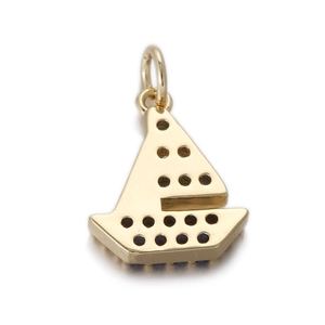 Detail view of a gold sailboat pendant featuring intricate dark navy blue gemstones
