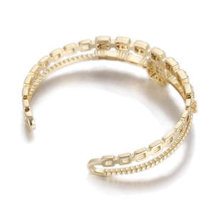 Detail of gold double-layer open bangle featuring geometric squares and beaded texture