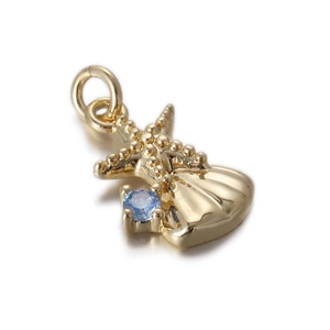 Macro shot of gold shell pendant featuring a sparkling sky blue zircon gemstone inlay
